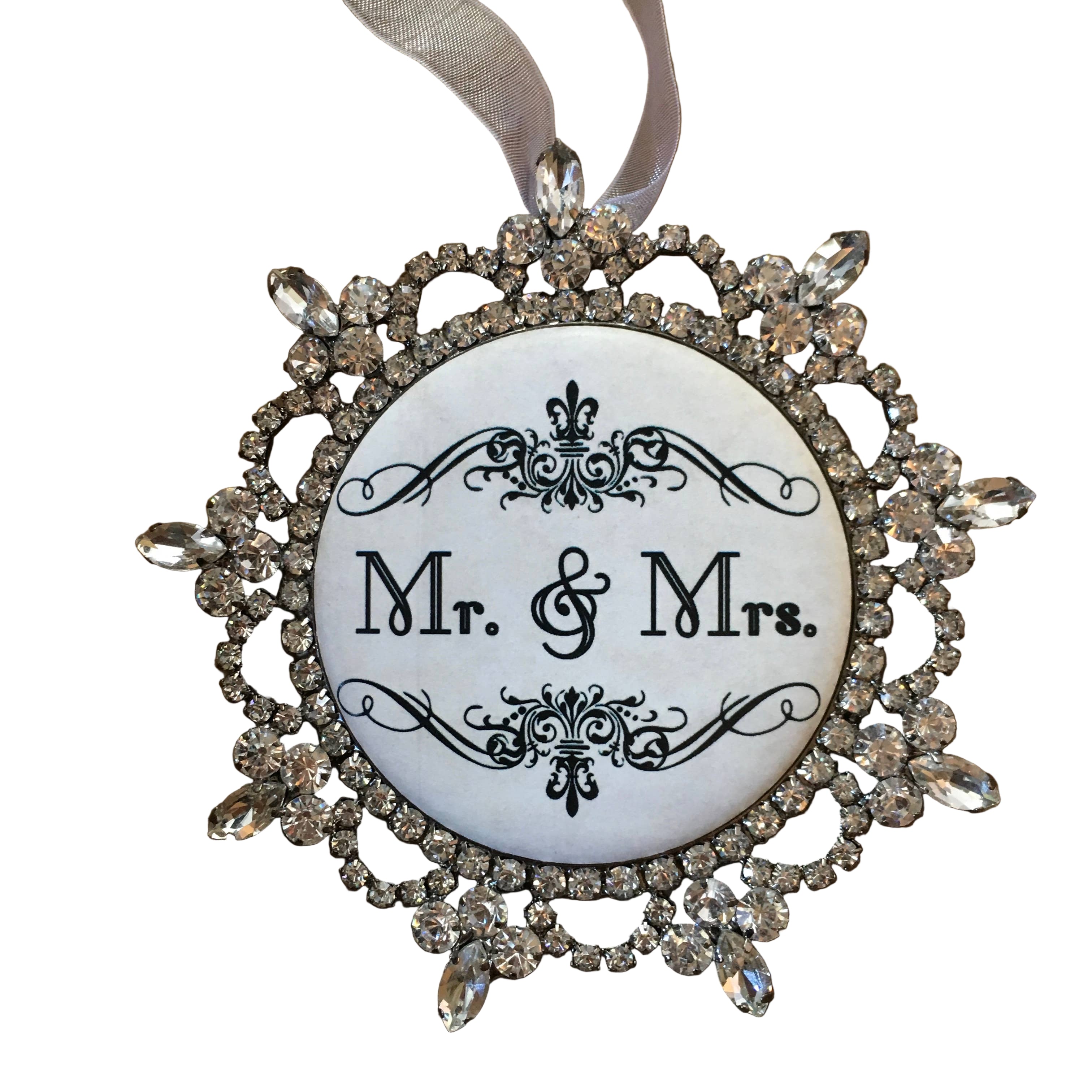 Decorative ornament with 'Mr. & Mrs.' text on a wooden background