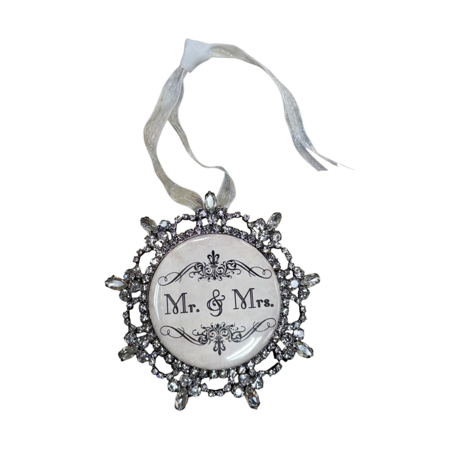 Decorative ornament with 'Mr. & Mrs.' text on a wooden background