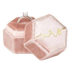 Pink velvet ring box with 'Mrs.' on a white background