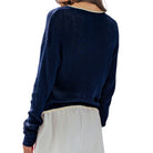 Navy blue sweater worn by a person on a white background