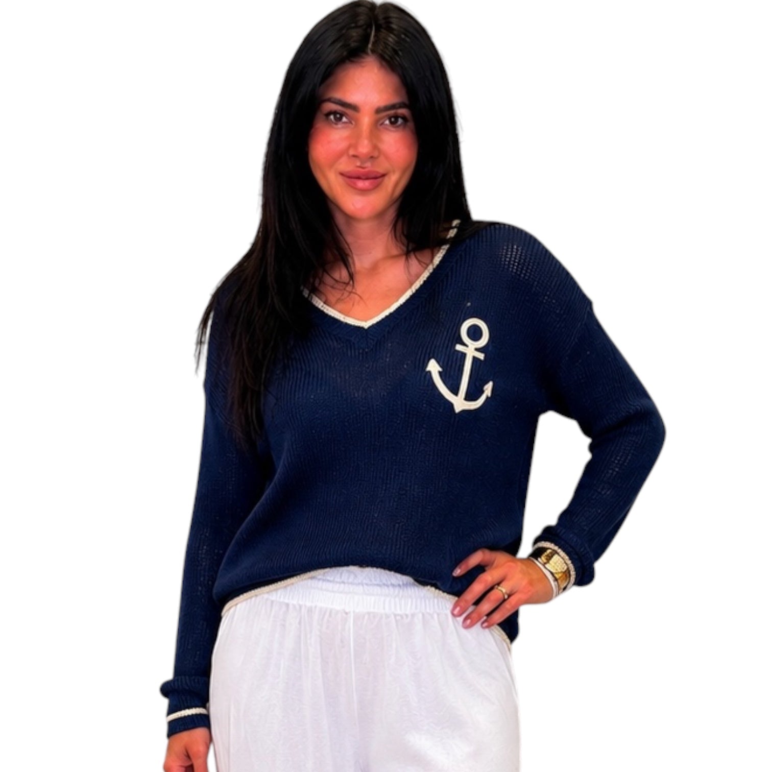 Woman wearing a navy blue sweater with an anchor design on a white background