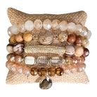 Stack of beaded bracelets on a textured surface