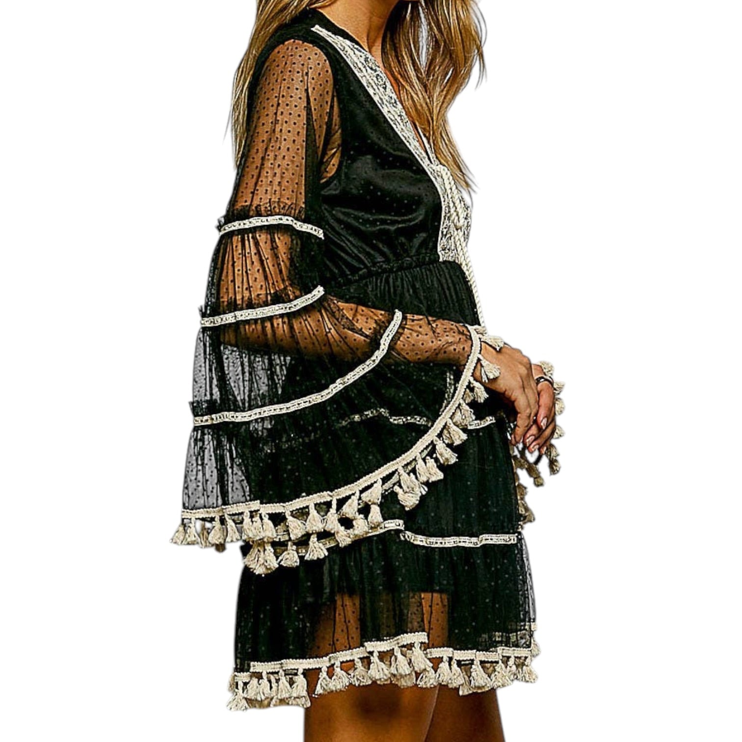 Black dress with white tassel details on a white background