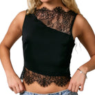 Black lace top worn by a person on a white background