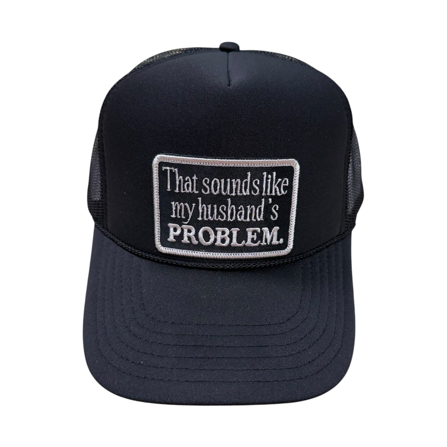 Black trucker cap with a white embroidered patch on a white background