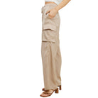 Nude cargo pants worn by a person on a white background