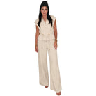 Woman wearing a beige set on a white background