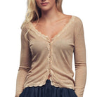 Beige long-sleeve top with lace details worn by a person on a white background