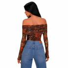 A woman shown from the back wearing a ruched off-the-shoulder long-sleeve bodysuit with a brown, orange, and red floral pattern, paired with blue jeans, against a plain white background.