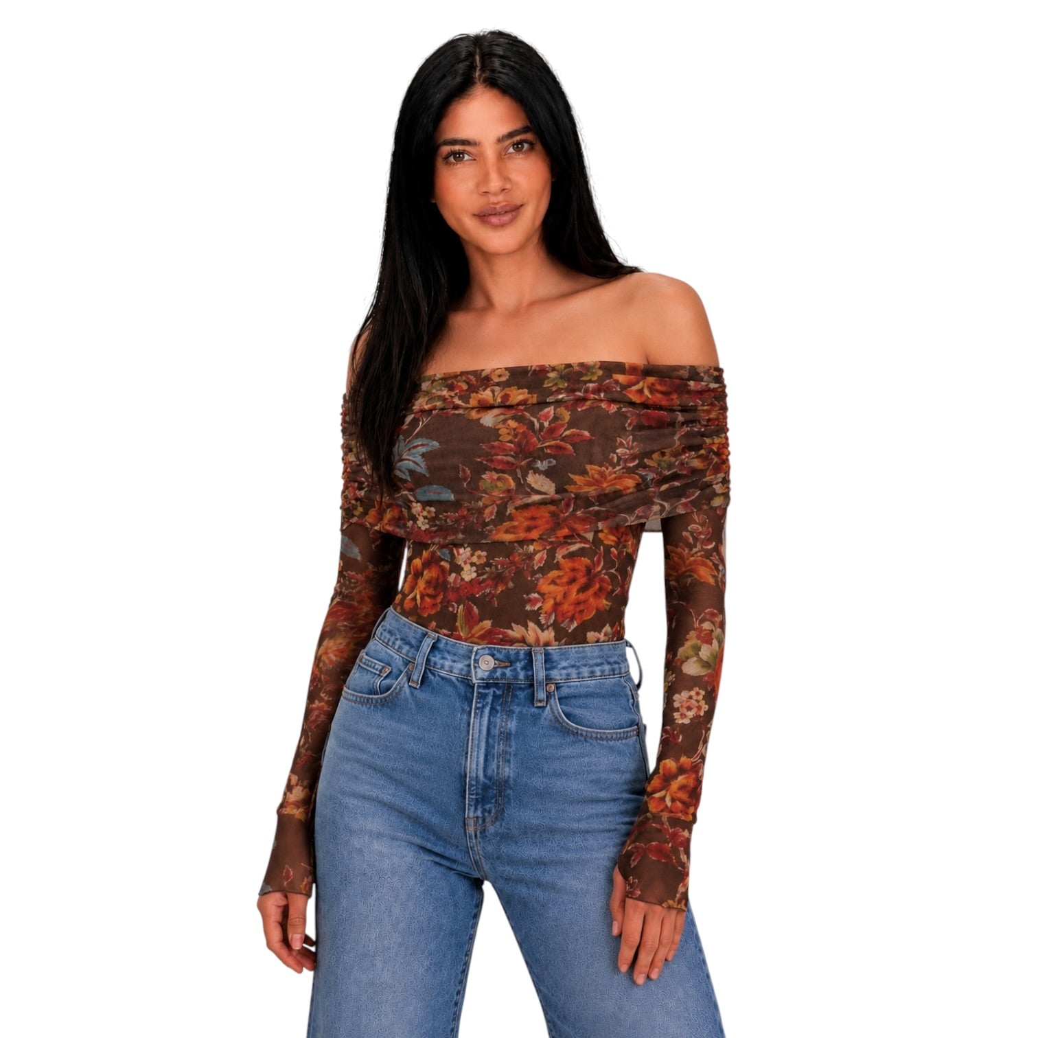 A woman modeling an off-the-shoulder long-sleeve bodysuit with a brown and rust floral pattern, paired with blue jeans, against a plain white background.
