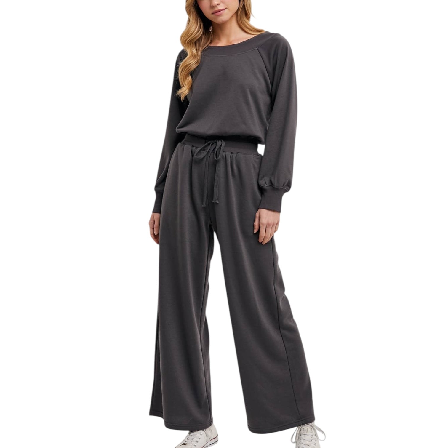 Woman wearing a gray jumpsuit on a white background