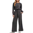 Woman wearing a gray jumpsuit on a white background