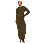 Woman wearing a long brown knitted dress with a hood on a white background