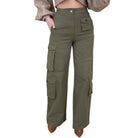 Green cargo pants worn by a person on a white background