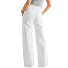 White pants worn by a person on a white background