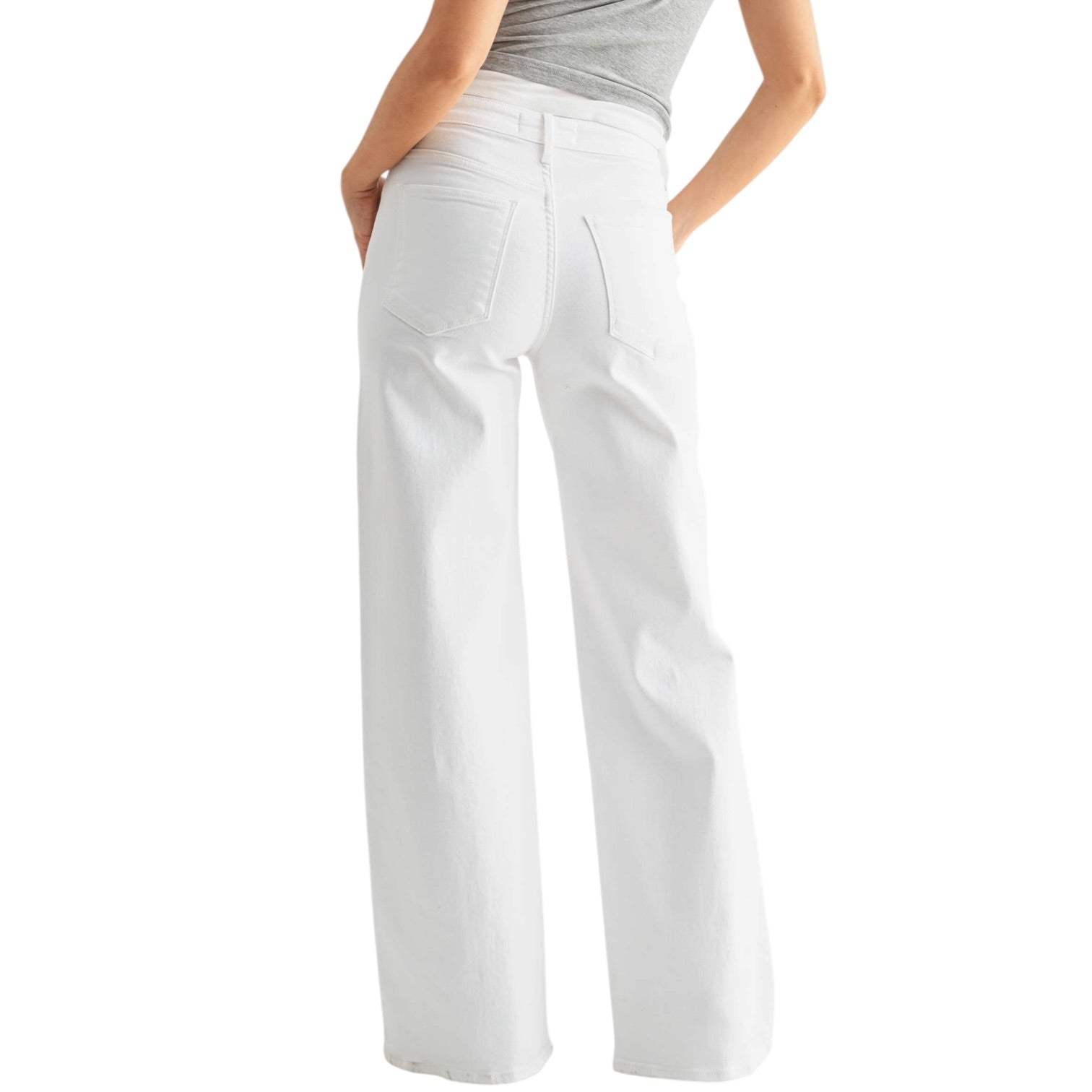 White pants worn by a person on a white background