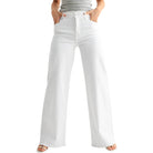 White jeans worn by a person on a white background