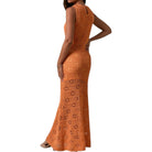 Woman wearing an orange crochet dress on a white background