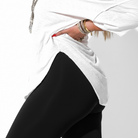 Person wearing a white hijab and black outfit on a light gray background