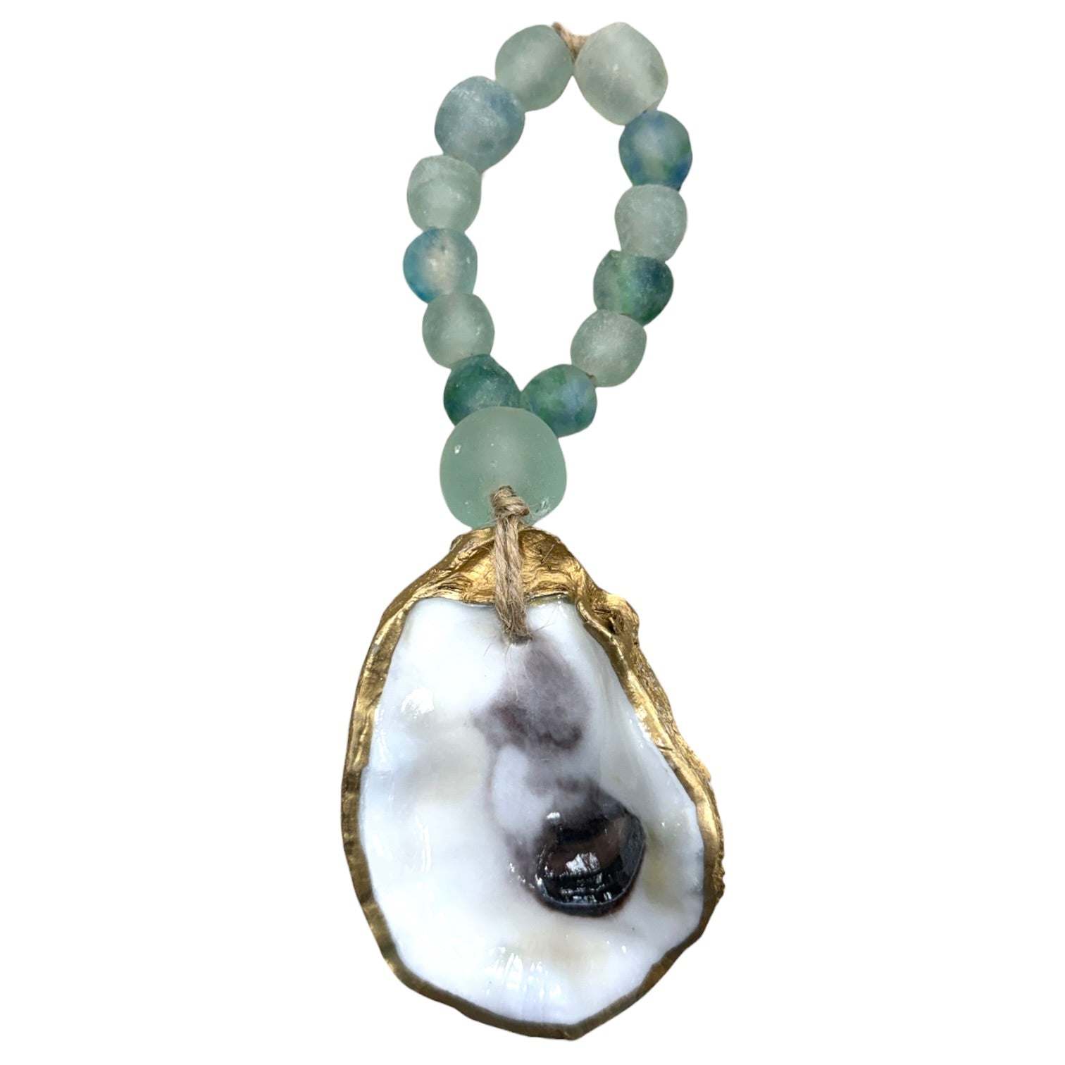 A beaded necklace with light green and blue-green beads and a large oyster shell pendant with gold trim and a dark central inlay, shown on a plain white background.