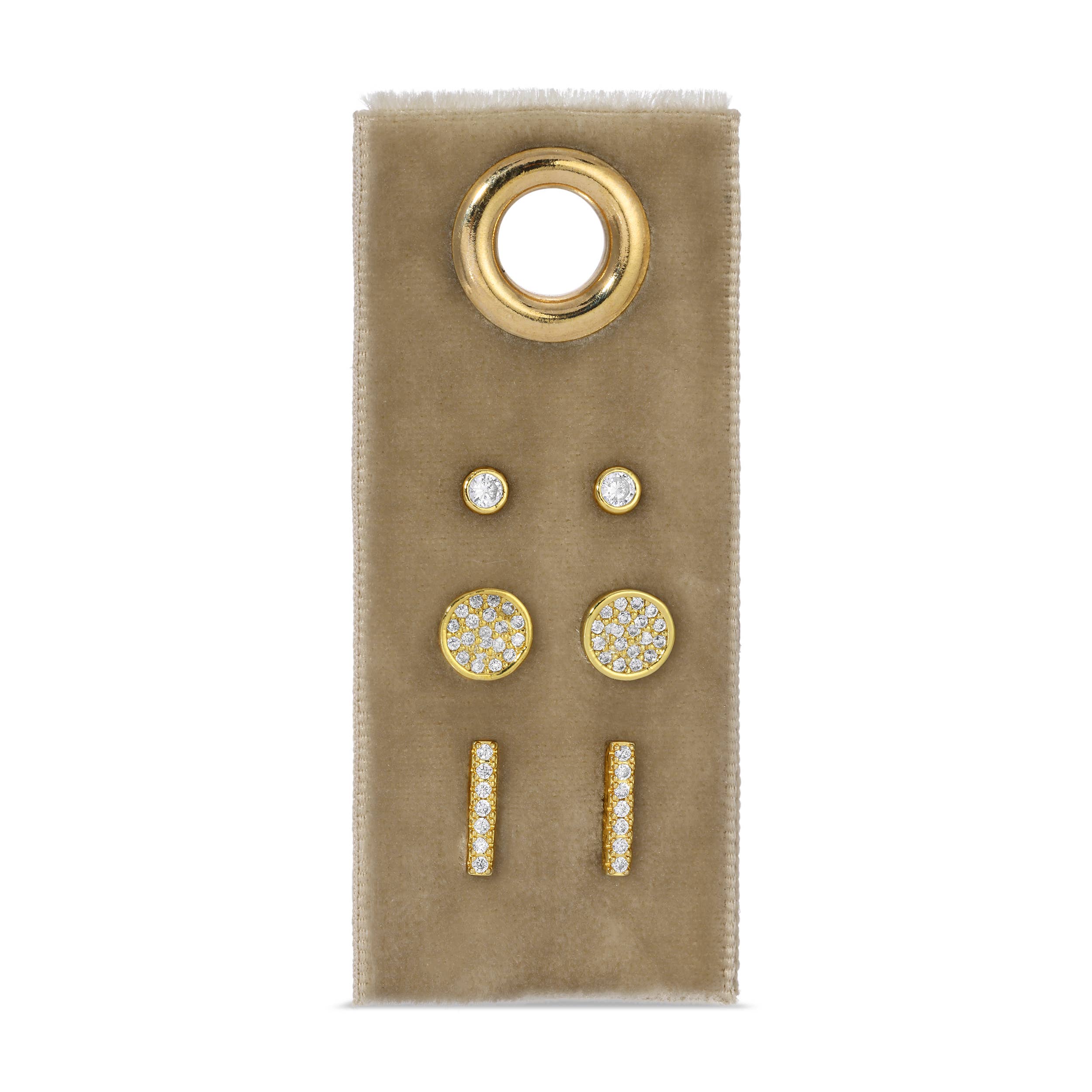 Set of gold and diamond earrings on a beige card with a white background