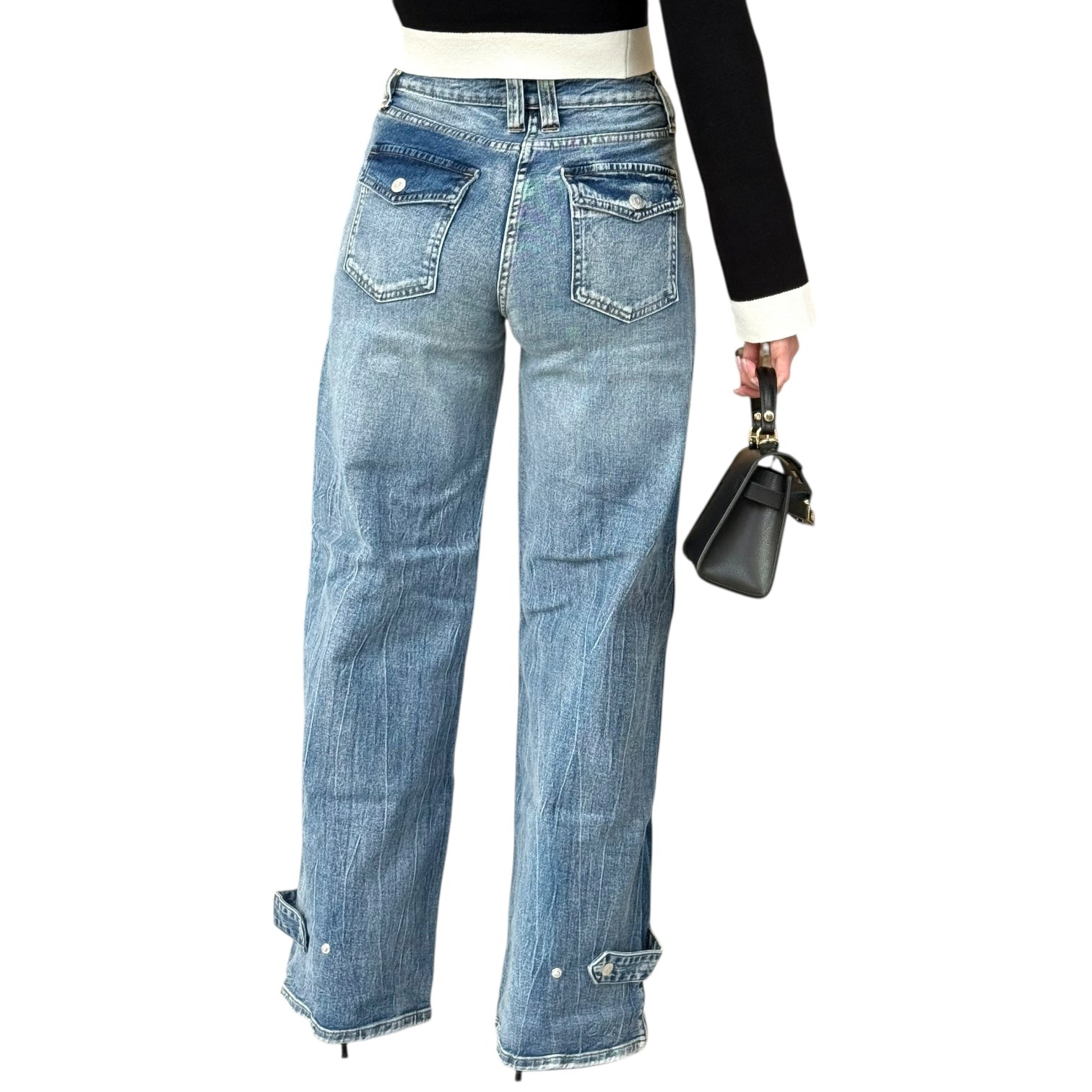 Blue jeans worn by a person on a white background