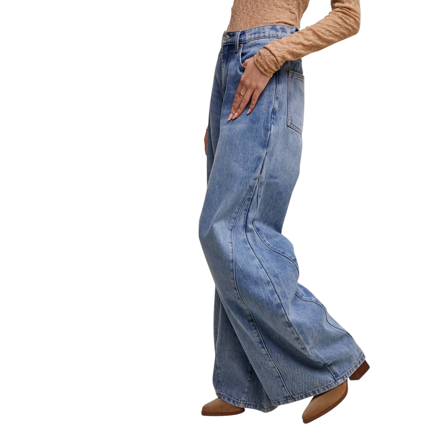 Person wearing blue wide-leg jeans on a white background