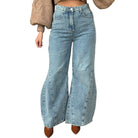 Wide-leg jeans worn by a person on a white background