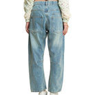 Blue jeans worn by a person on a white background