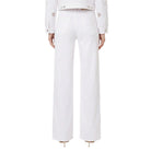 White pants worn by a person on a white background