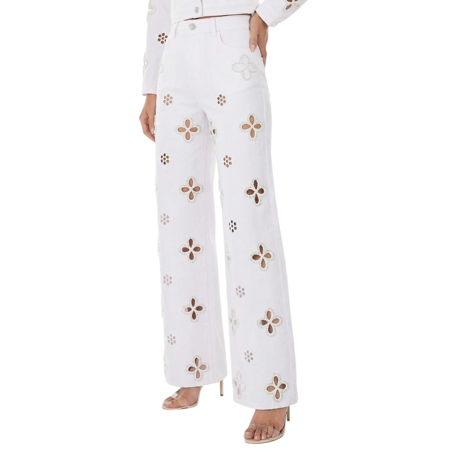 White pants with floral patterns worn by a person on a white background