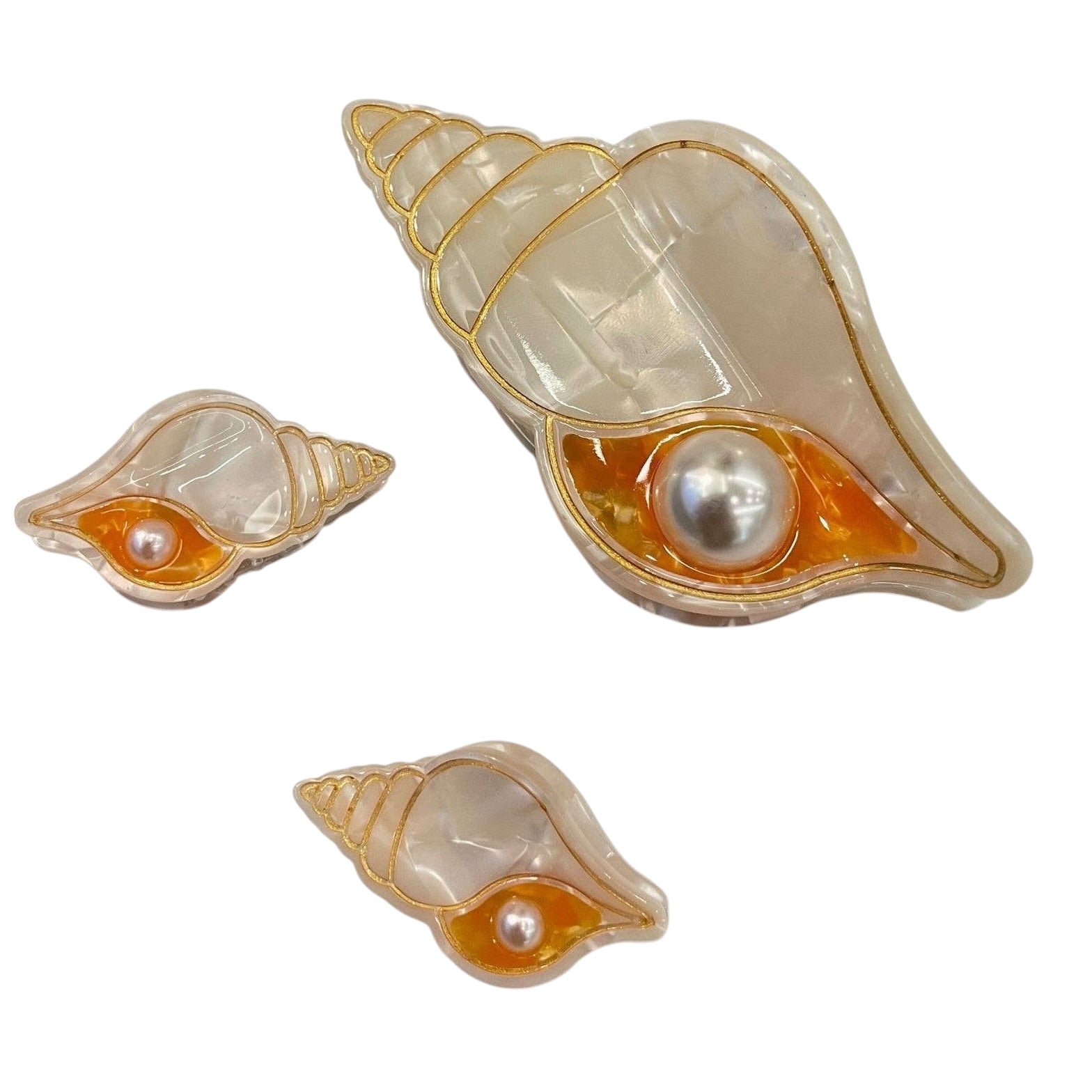 Shell-shaped claw clip with pearl inside on a white background