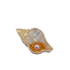 Shell-shaped claw clip with a pearl on a white background