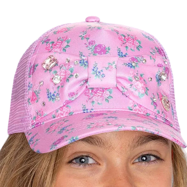 Pink floral cap with decorative elements on a light blue background