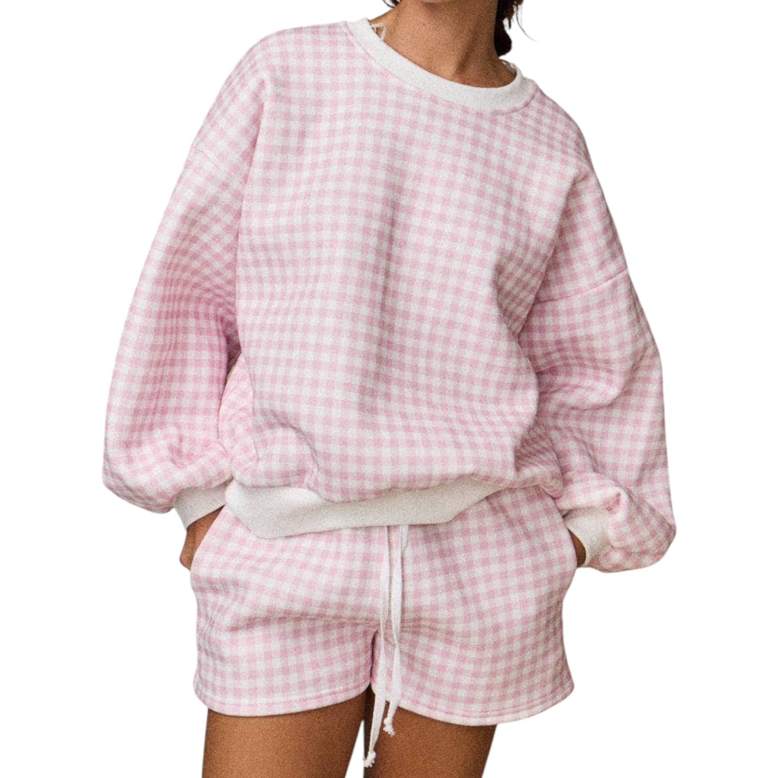 a woman wearing a pink gingham set on white background