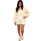 Person wearing a yellow checkered outfit on a white background