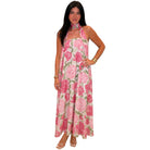 Woman wearing a pink floral dress on a white background