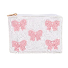 White pouch with pink bow designs on a white background