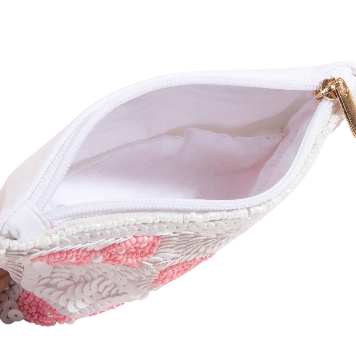 Close-up of a white lace bra with pink accents on a white background