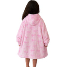 A child viewed from behind wearing a pink hooded robe with an allover light pink bow pattern, set against a plain white background.
