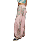 Pink wide-leg pants with floral patterns on a white background