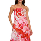 Woman wearing a strapless set with red, pink, and white floral pattern on a white background