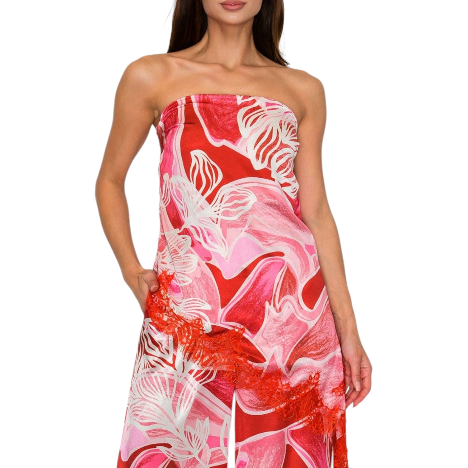 Woman wearing a strapless set with red, pink, and white floral pattern on a white background