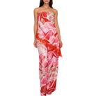 Woman wearing a strapless set with red and pink floral pattern on a white background