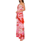 Woman wearing a strapless floral set with red and pink pattern on a white background