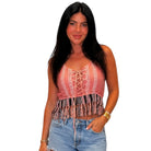 Woman wearing a patterned top and jeans on a white background