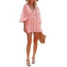 Woman wearing a pink lace dress on a white background