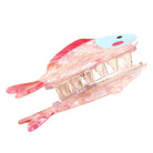 Fish-shaped claw clip with pink fins on a white background