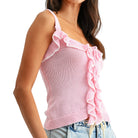 Pink ruffled tank top worn by a person on a white background