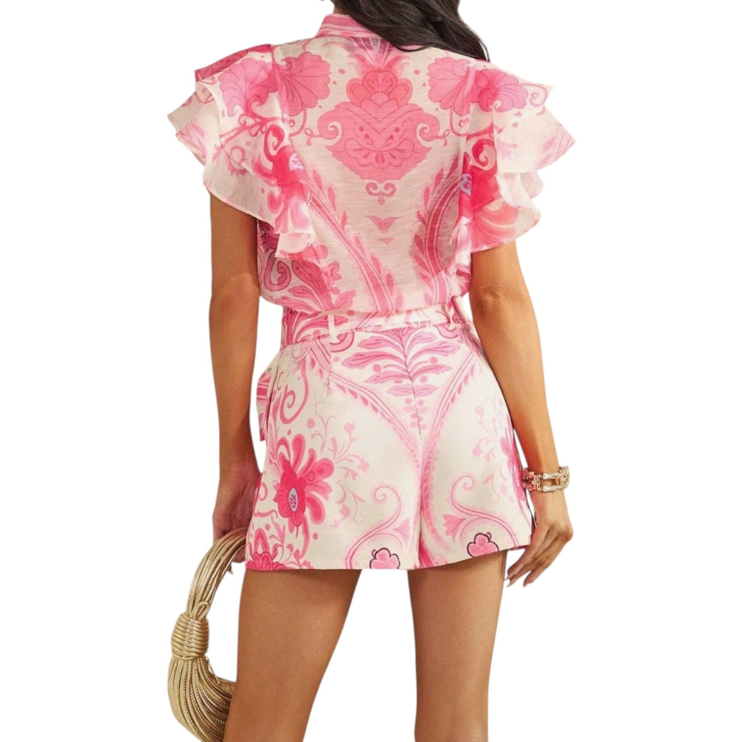 a woman wearing a pink patterned short set on white background